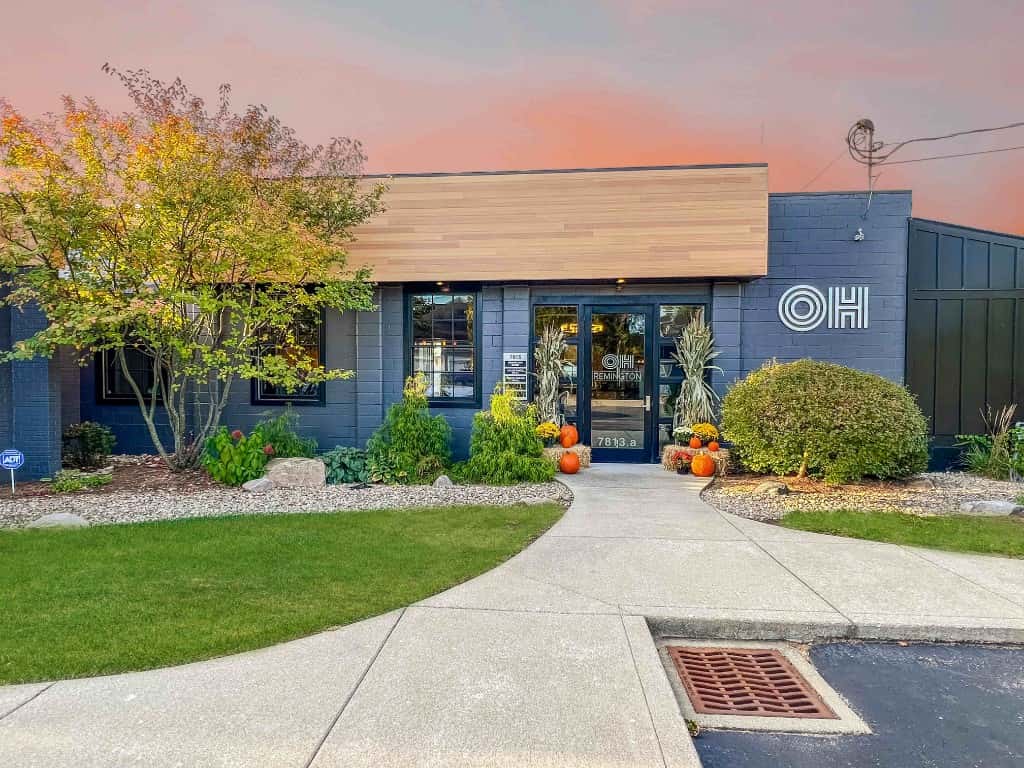 The Remington Room exterior at sunset with autumn decor at the entrance